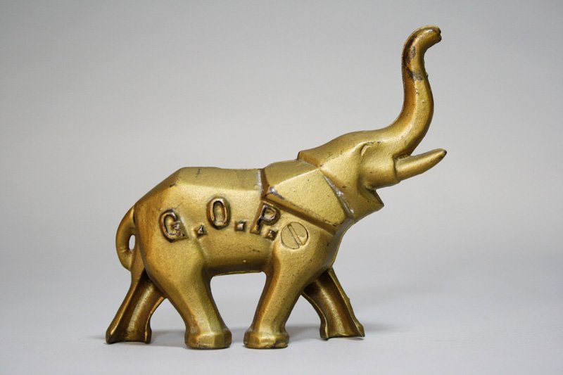 Art Deco “GOP” Elephant Still Bank: Made by A. C. Williams Ravenna, Ohio – Circa 1920 This example is truly Mint. The screw has never been turned. Material: Cast Iron •