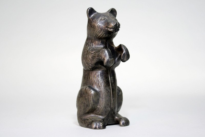 Begging Bear with Fine Fur Still Bank: Probably A. C. Williams – Circa 1920 This bear has much finer details than its usual gold painted counterpart. It is painted with black japanning. We have not seen him before. Material: Cast Iron