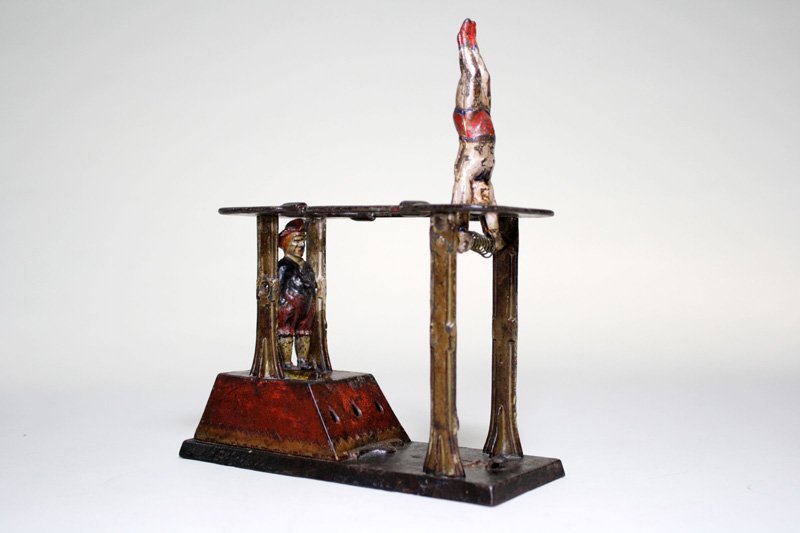 Acrobat Bank Mechanical Bank: Made by the J. & E. Stevens Company Cromwell, Connecticut – Circa 1883 Lock both figures into place and put a coin into the slot. Press the lever and the gymnast is released kicking the clown, causi