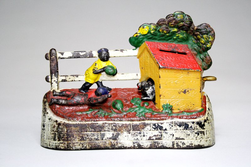 Boy Stealing Watermelons – Solid Colored Outfit Me: Made by Kyser & Rex Philadelphia, Pennsylvania – Circa 1890 Place a coin in the doghouse roof slot. Depress the lever and the dog comes out to frighten the boy. As he reaches for his watermelon, the