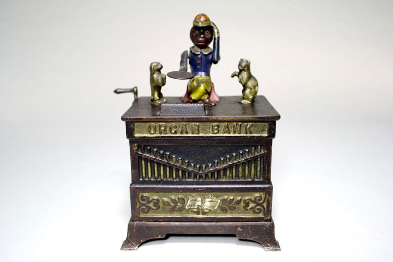 Organ Bank, Cat and Dog Mechanical Bank: Made by the Kyser & Rex Company Philadelphia, Pennsylvania – Circa 1882 The monkey doffs his hat in thanks for the penny you have given him. The animals rotate and the bells chime when the crank is