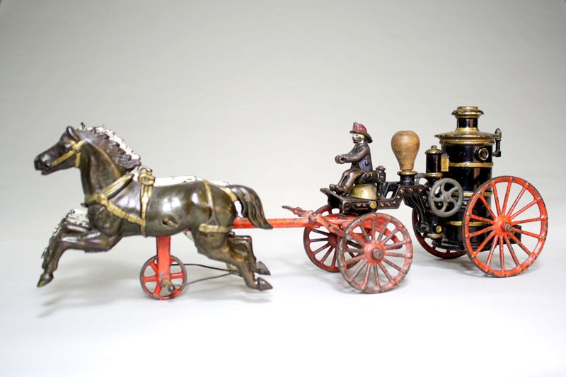 Phoenix” Fire Pumper Cast Iron: Ives Blakeslee Company Bridgeport, Connecticut – Circa 1892 This is part of the “Royal Flush” of Fire Toys made by Ives. It is in unusually fine condition. The toy is 18” long. Material: Cast 