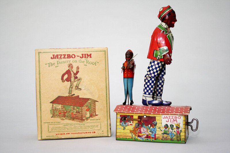 Jazzbo Jim with Box: Made by Unique Art Newark, New Jersey – Circa 1925 This is a wonderful and graphic lithographed windup tin toy. It works well. Material: Tin