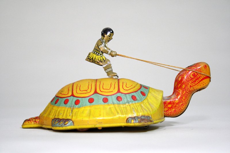 Black Native Riding a Turtle: Made by J. Chein Co. Newark, New Jersey – Circa 1935 This is quite a scarce and charming windup toy. It works well. Material: Tin