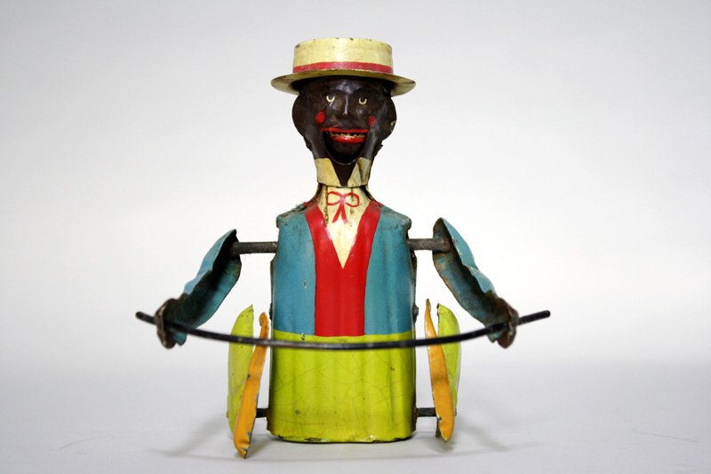 Black Man Tumbling: Made by Gunthermann • German – Circa 1905 This toy is truly colorful and rare. We have never seen it before, but his tooth action is similar to the black man rocking in the chair also by Guntherma