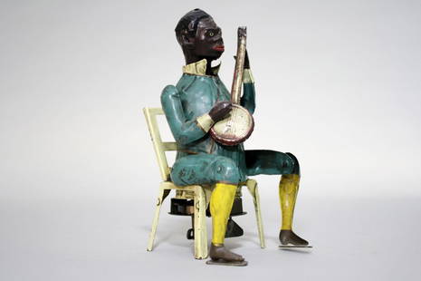 Black Banjo Player: Made by Gunthermann • German – Circa 1910 This is a wonderful, colorful and iconic toy produced in Germany before WWI. It is a superior example and works well. Material: Tin •