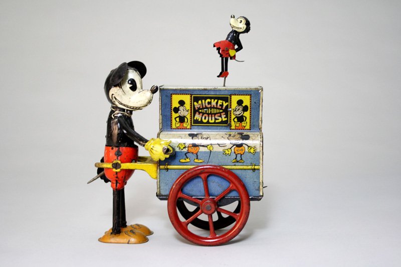 Mickey Mouse Hurdy-Gurdy Wind Up Toy: Germany – Circa 1930 This is an extremely rare and comical German windup toy. This toy works quite well. This is a chance to own a graphic 1930’s lithography toy. Material: Tin