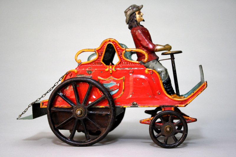 Early Steam Auto Buffalo Bill Wind Up Toy: French – Circa 1895 Buffalo Bill toured the European Continent in the years 1891 and 1892. We surmise that this was the steam-powered auto that he used during that trip. The toy is 11” long and wo