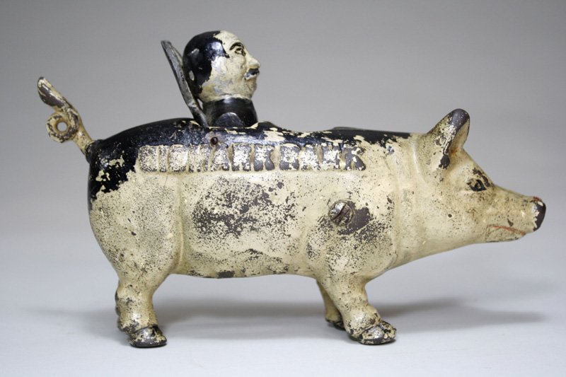 Bismark Pig (Early Second Casting) Mechanical Bank: Made by the J. & E. Stevens Company Cromwell, Connecticut – Circa 1930 This is an extremely rare bank depicting Otto Von Bismark popping out of a pig. The inspiration of this bank derives from Ameri