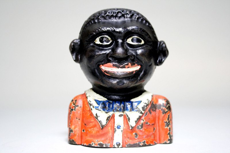 Young Negro Bank, Cast Iron Mechanical Bank: England – Circa 1920 This is a scarce and desirable bank. Material: Cast Iron •