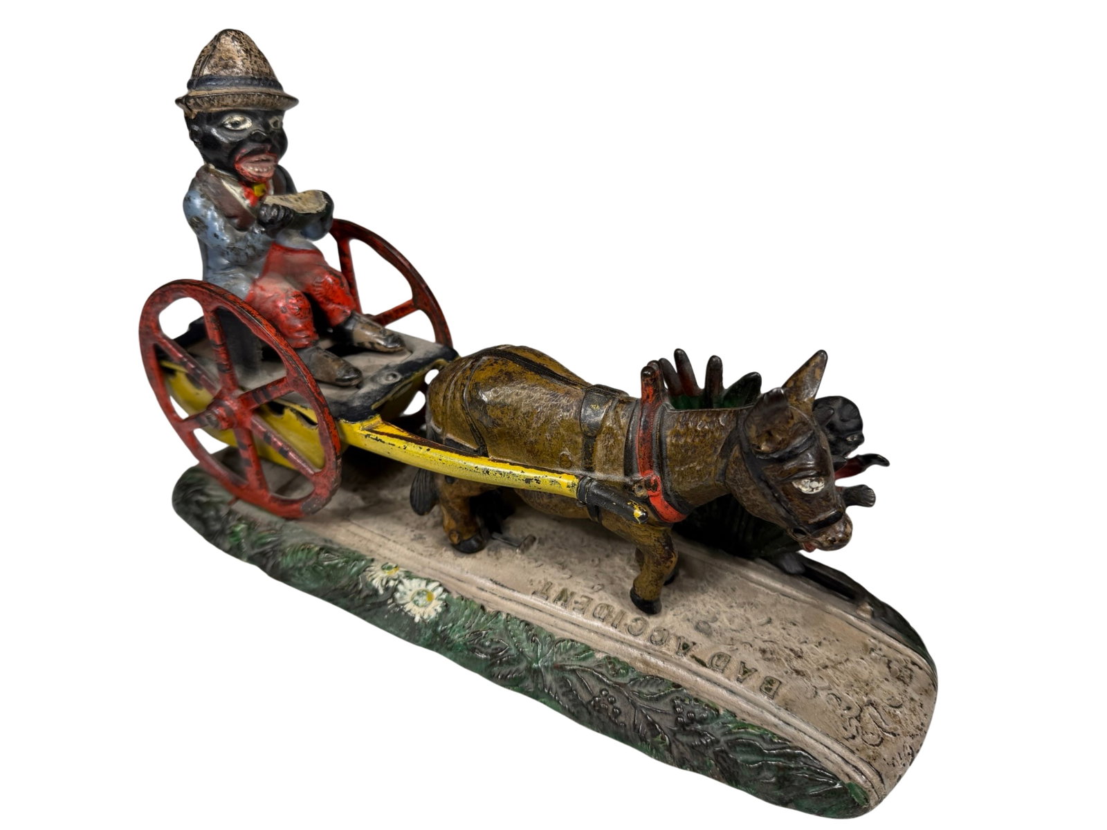 Bad Accident - Cast Iron Mechanical Bank: J & E Stevens Company. Cromwell, Connecticut, Circa 1888. When the bank is activated, a little boy emerges from behind the bulrushes, frightening the mule and thereby toppling the cart backwards. In s