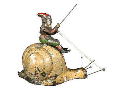 Gnome Riding Atop a Snail - Wind Up Toy: Made by Sigmund Gunthermann. Germany - Circa 1895 - 8 1/2" Long. This novel fantasy toy represents one of the rarest of all of Guntermann's creations. It has been suggested that the coupling of the ti