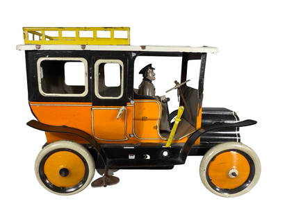 Edwardian Era Yellow Taxicab: Made by Greppert & Kelch Company. Germany - Early 1910's - 6 3/4" Long. This early taxicab takes its design cues from the cabriolet carriage silhouette. Though relatively small in scale, the toy featu