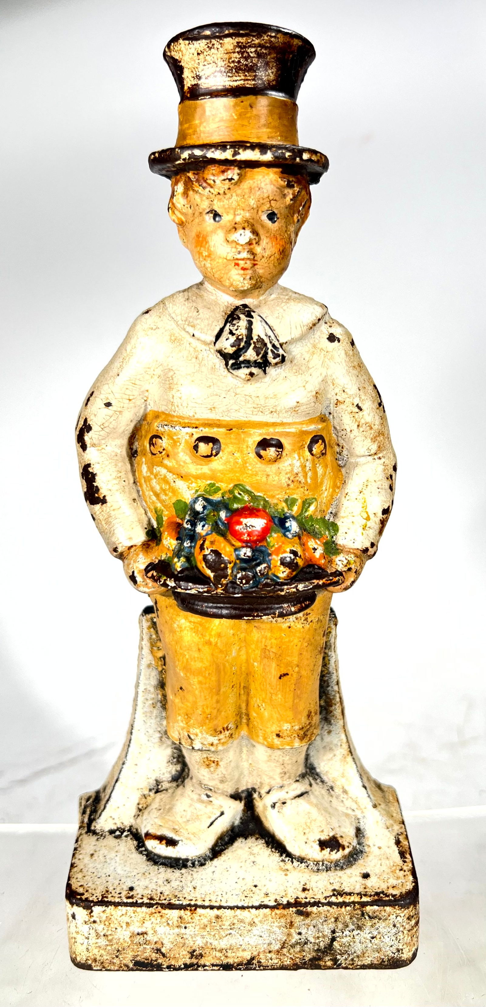 Boy with Flower Basket Cast Iron Doorstop: Albany Foundry Co. American 1915 - 9 1/4"T