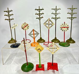 Twelve American Flyer Accessories - Four Telephone Poles / Three Clocks / Four Warning Signs / One