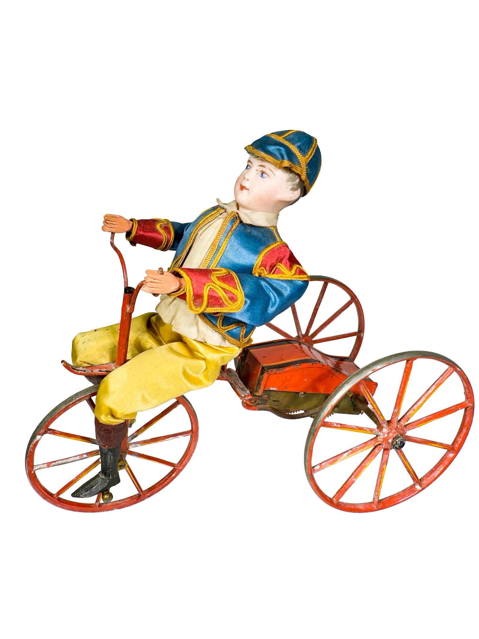 Fanciful Dressed Young Man Riding a Tricycle - Wind Up Toy: French - Circa 1890. 9" L x 7 1/2" T x 4 1/4" D. Early, delicate toys such as this are seldom seen in such fantastic condition. The toy worked very well when tested.
