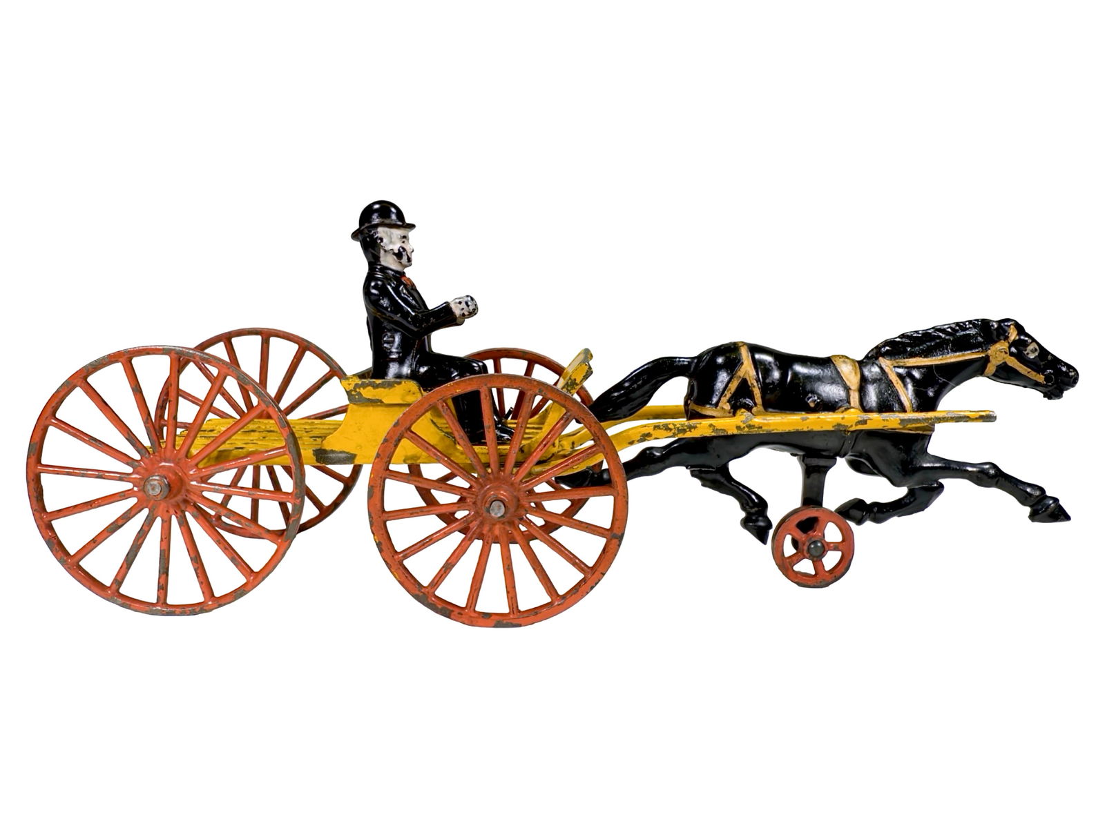 Scarce Buckboard with Slatted Bed - Cast Iron Toy: Made by the Hubley Mfg. Company. Lancaster, Pennsylvania - Ca. 1906. 13 1/2" L x 5 1/2 T x 3 1/2" D. This vividly colored cast iron toy is highly emblematic of Hubley's creative output during the earl