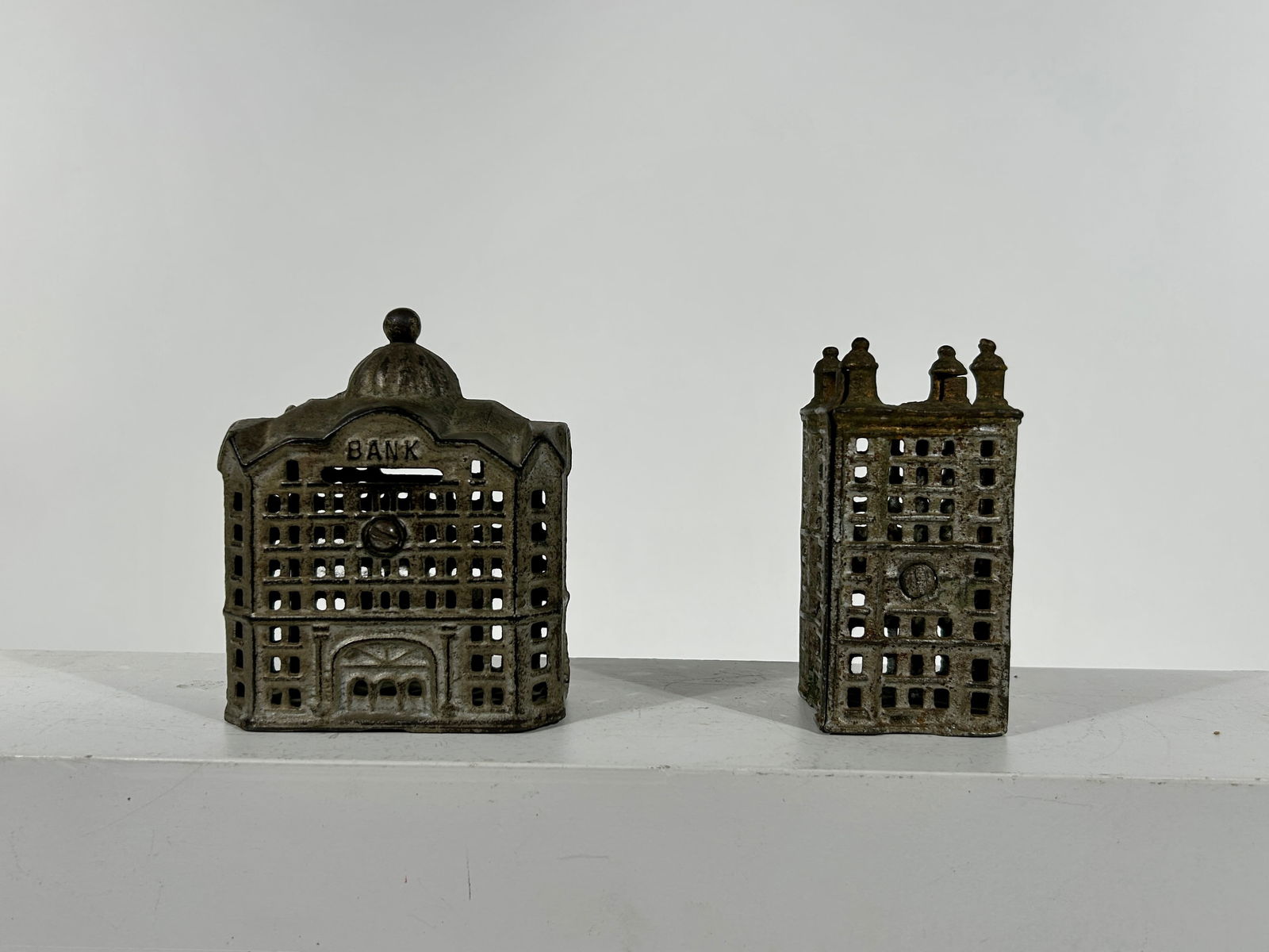 Two City Themed Cast Iron Building Banks: A.C. Williams Co. - Ravenna, OH. 1920 - Both 5"Tall