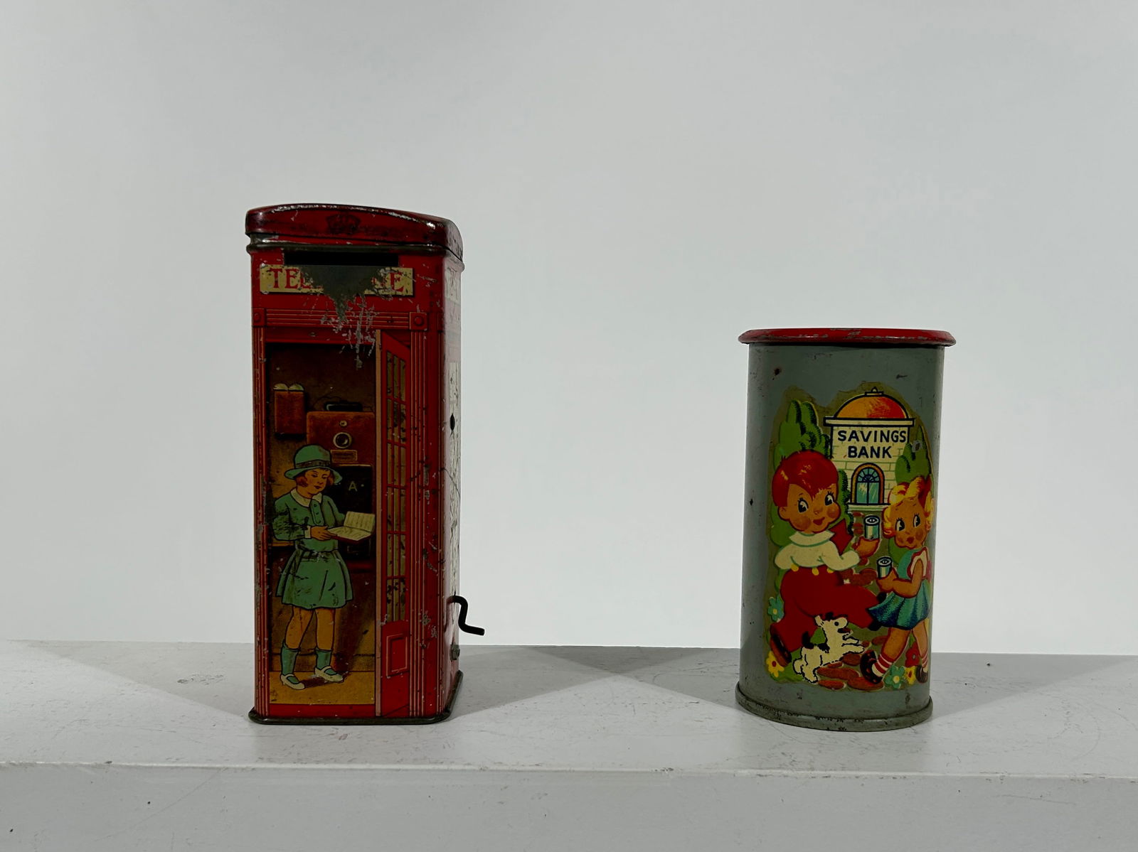 Two Tin Still Banks: English 1930's - 5" to 6" Tall Respectively