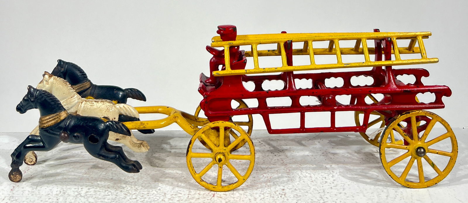 Three Horse Cast Iron Hook and Ladder: Made by Kenton Hardware Company. Kenton, Oh. - 1920's. 11 1/2"L x 3 3/4"T x 2 1/4"D. The Olshefski Collection.