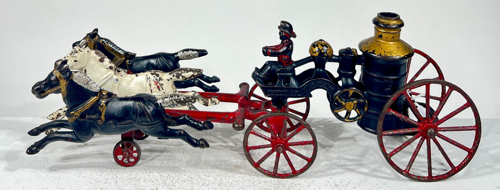 Three Horse Cast Iron Fire Pumper: Kenton Hardware - Kenton, OH. 1915 - 15 1/4"L x 5 3/4"T x 3 1/4"D The Olshefski Collection