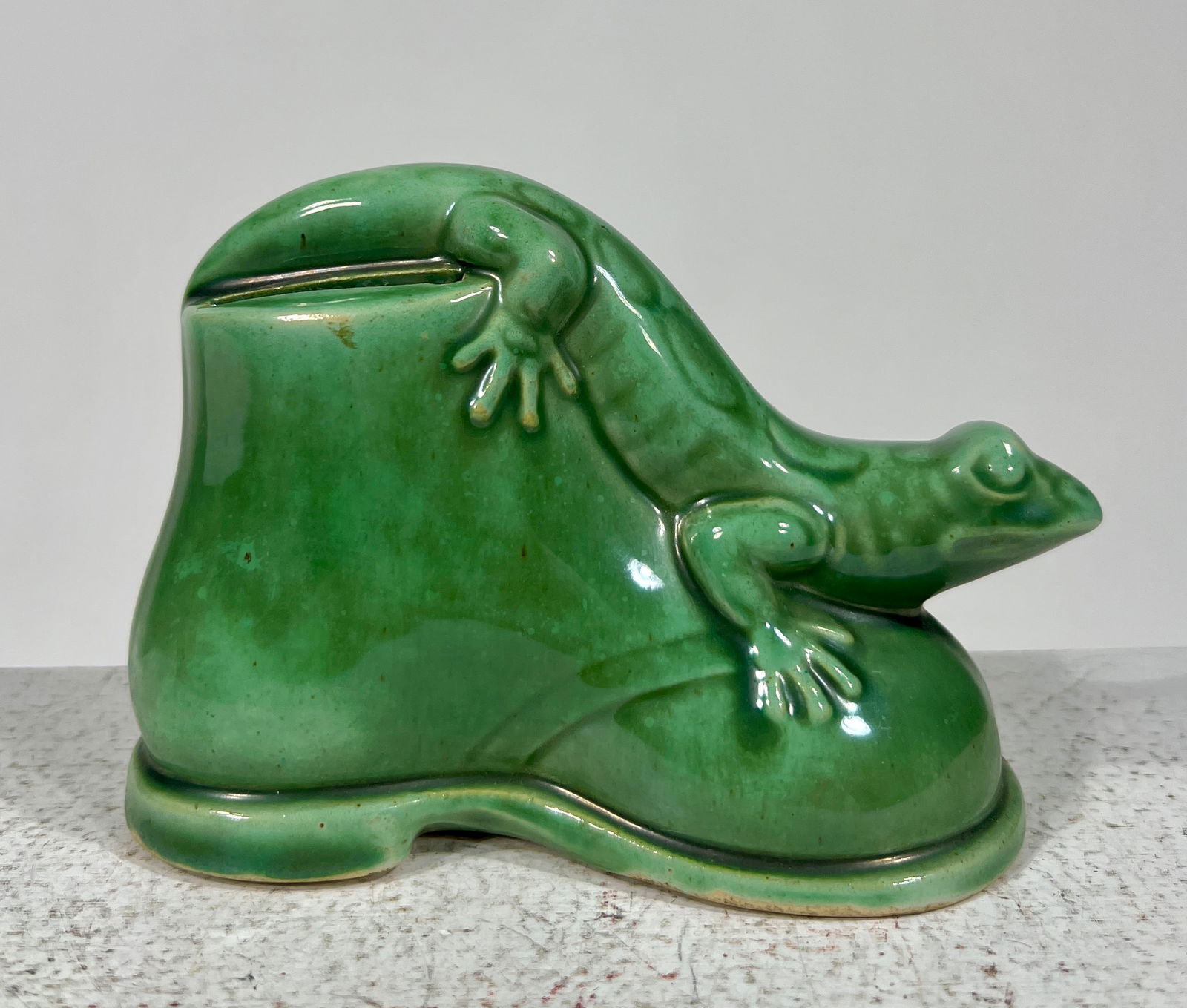 Salamander on a shoe Pottery Bank with Advertising: German- 1930 4 3/4" L x 3 1/4"T x 2 1/4"D The Peirce Collection