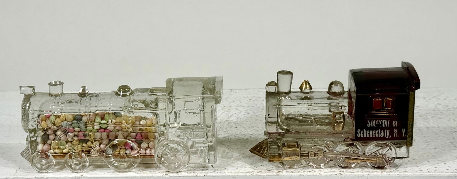 Two Glass Candy Container Locomotive: One- Souvenir of Schenectady, NY Victory Glass coAmerican- 1930's Larger is- 5 1/4"L x 1 ?" T x 1 1 1/4"DThe Peirce Collection