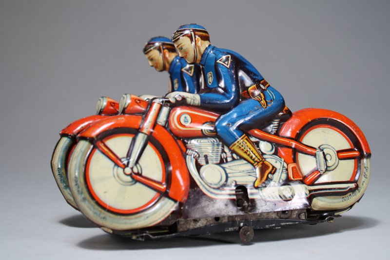 Side by Side Police Motorcycle: Niedermeier Made in Western Zone Germany – Circa 1948 This is a wonderful windup pairing made just after World War II. It is quite scarce, in fact, we have not seen another example. The toy is 6 ½�