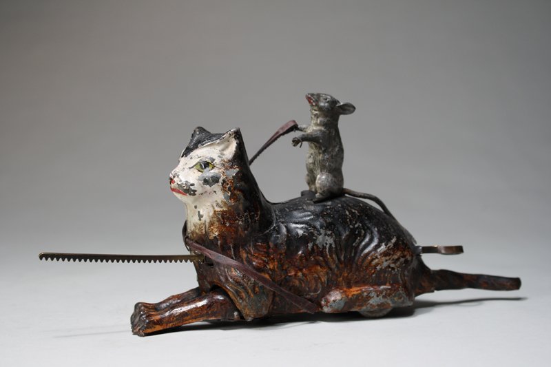 Cat and Mouse Gyroscopic Toy: Germany – Circa 1915 This is the finest gyroscopic toy that we have ever seen. It is wonderfully painted, works well and is 9” long. The cats front paws go up and down as it moves. Material: Tin