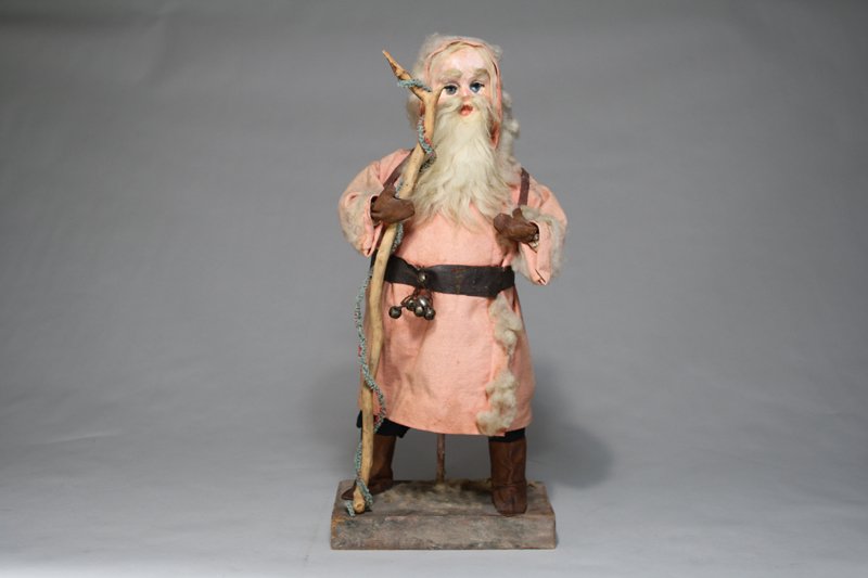 Santa Claus on Base: Germany – Circa 1910 Made of papiermache and fabric on a wooden base. He stands 22” tall. Material: Papiermache, Fabric and Wood