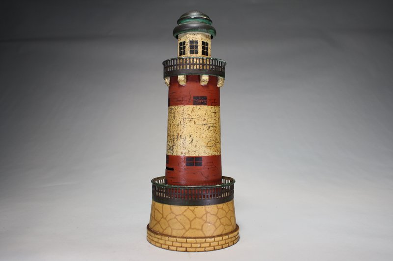 Lighthouse Bank Archiectural Bank: Gebruder Bing Germany – Circa 1895 An extremely rare tin hand painted bank by Gebruder Bing 13” in height. Material: Tin