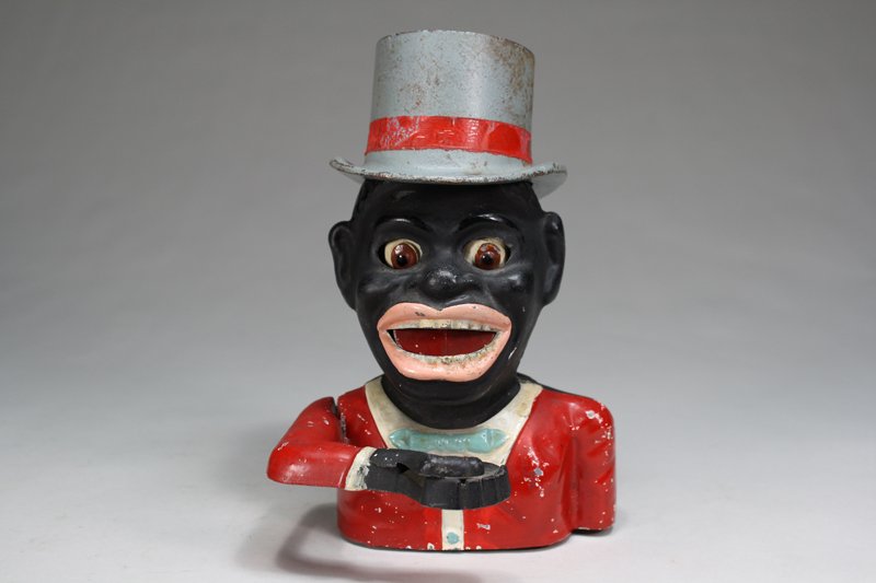 Jolly N. - Gray High Hat Mechanical Bank: Made by Sydenham & McOustra England – Circa 1930 This is a scarce later version of the John Harper bank. The screw to secure the original hat is not present. Material: Cast Alloy