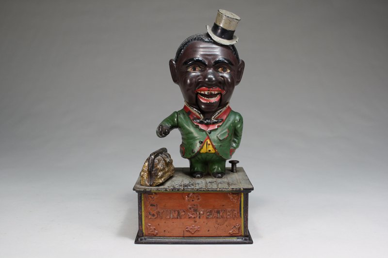 Stump Speaker Mechanical Bank: Shepard Hardware Company Buffalo, New York – Circa 1886 Place a coin in his hand, depress the lever, and the coin is deposited to the bank. Material: Cast Iron