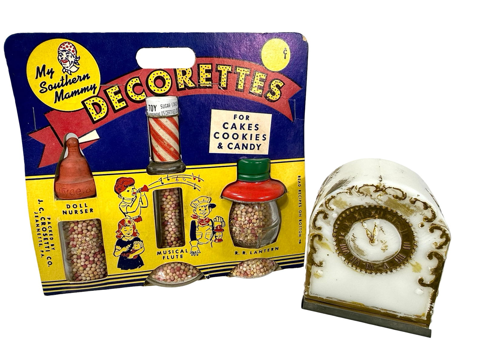 Three Candy Containers in Original Packaging and a Milk Glass Clock: American 1920/1950. The Peirce Collection.