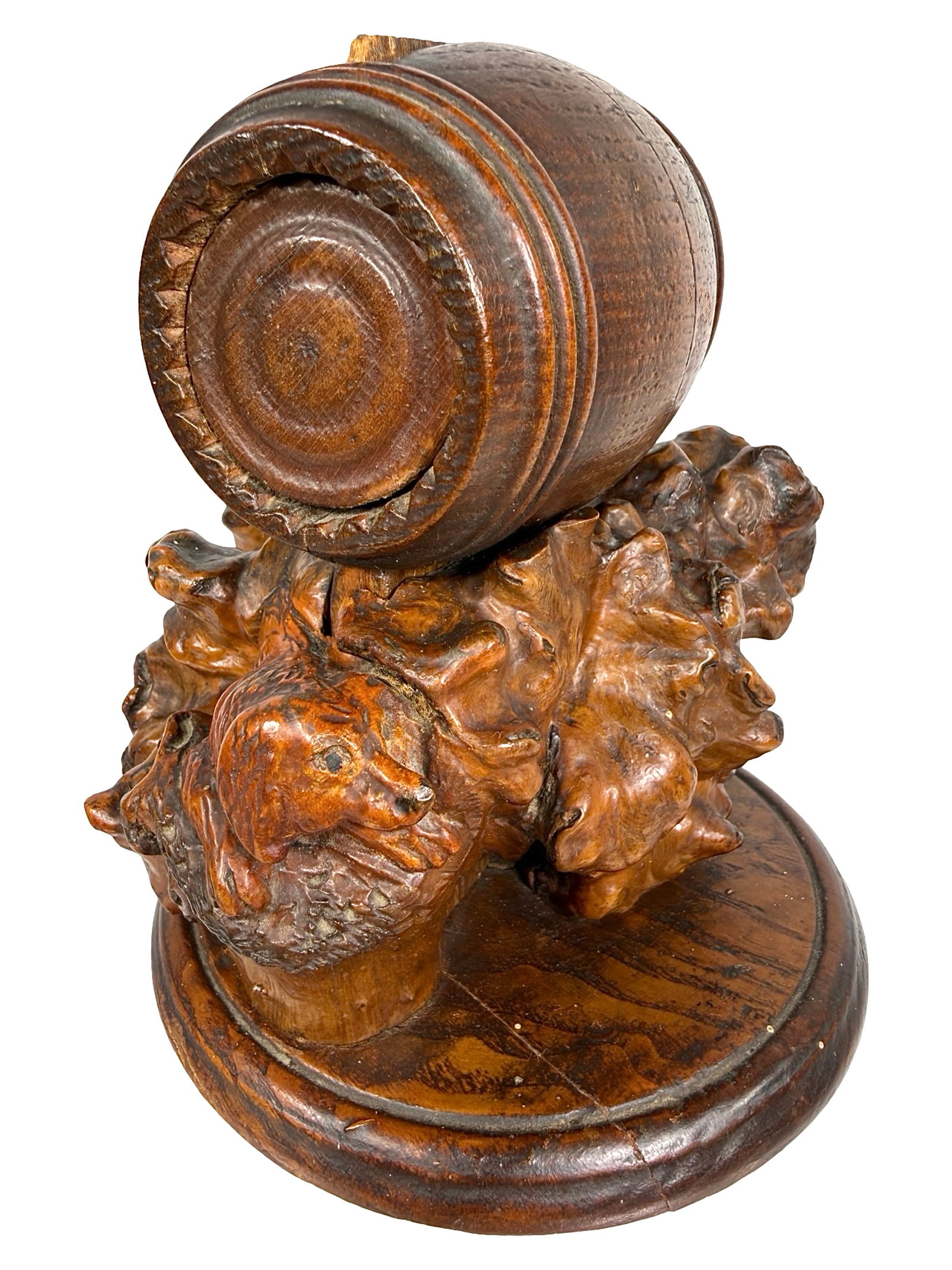 Barrel on top of a Gnarled Wood Burl Bank: Hand Carved Folk Art. American - Circa 1890. 5 3/4" Tall x 5" Diameter. Bob and Shirley Peirce Collection. The artisan has taken a well formed wood burl and carved images of a crouching dog making cha