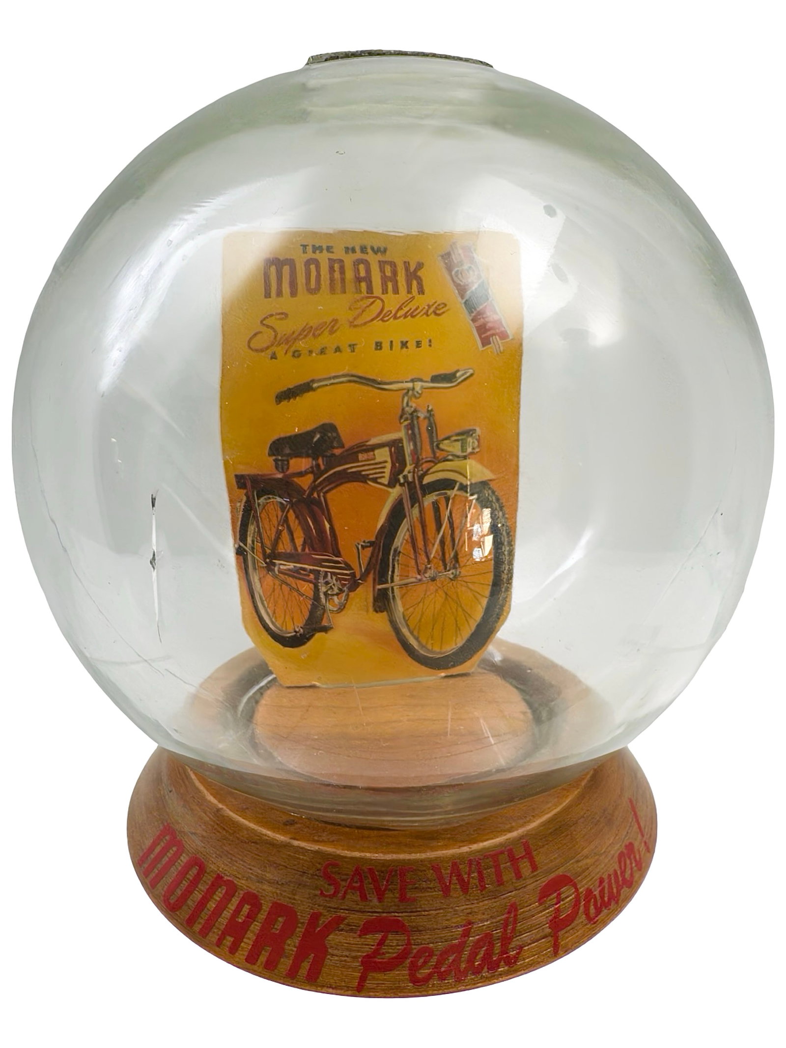 "Save with Monark Pedal Power!" Bubble Bank: Image of their Super Deluxe Bicycle. Made by the Vic Moran Company. Bradford, Pennsylvania - Ca. 1950. 7" Tall x 6" Wide. Bob and Shirley Peirce Collection.