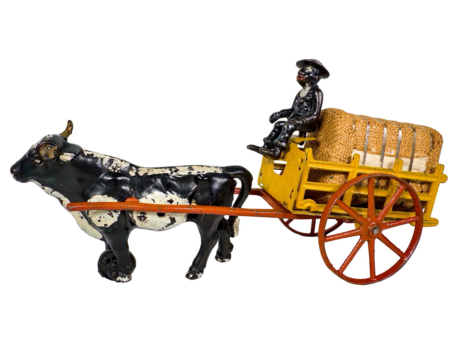 Ox Drawn Hay Cart - Cast Iron Toy: Sheet Steel and Cast Iron. By the Hubley Mfg. Company. Lancaster, Pa. - Early 1900's. 12 3/4" Long x 7 1/8" Tall. The John & Kira Olshefski Collection. Including a vintage souvenir bale of hay to such