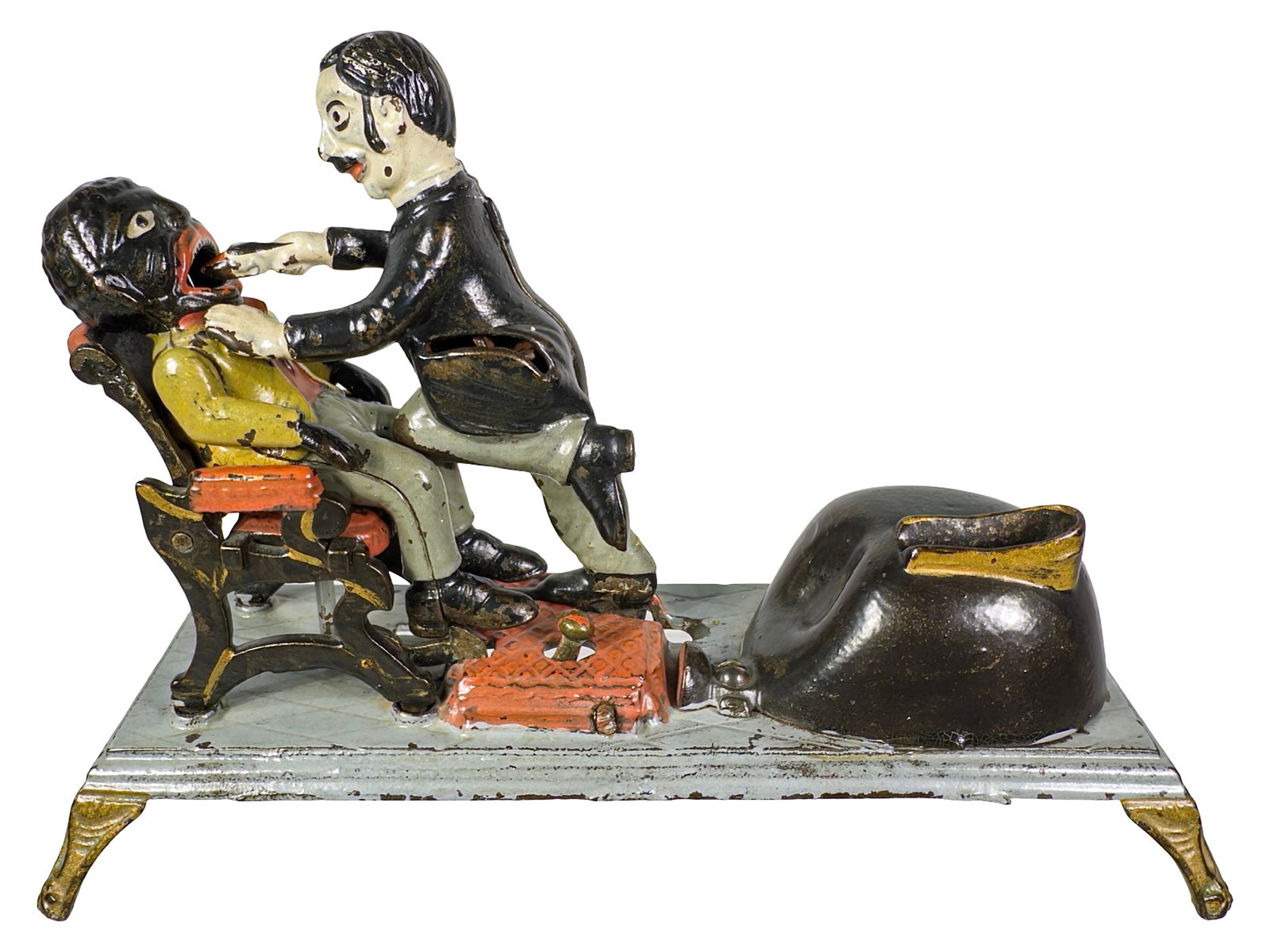 The Dentist - Mechanical Bank: By the J. & E. Stevens Company. Cromwell, Ct. - Circa Mid 1880's. From the Clive Devenish Collection. From the Peter Brown Collection. The Dentist Bank forms part of the quartet of toy banks known as 