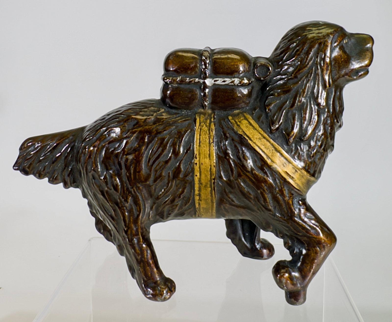 St. Bernard with Pack - Large, Japanned with Gold Highlights - Still Bank: A.C. Williams Company. Ravenna, OH. 1920's. 5 1/8" Tall x 7 5/8" Long. Tom Kellogg Collection.