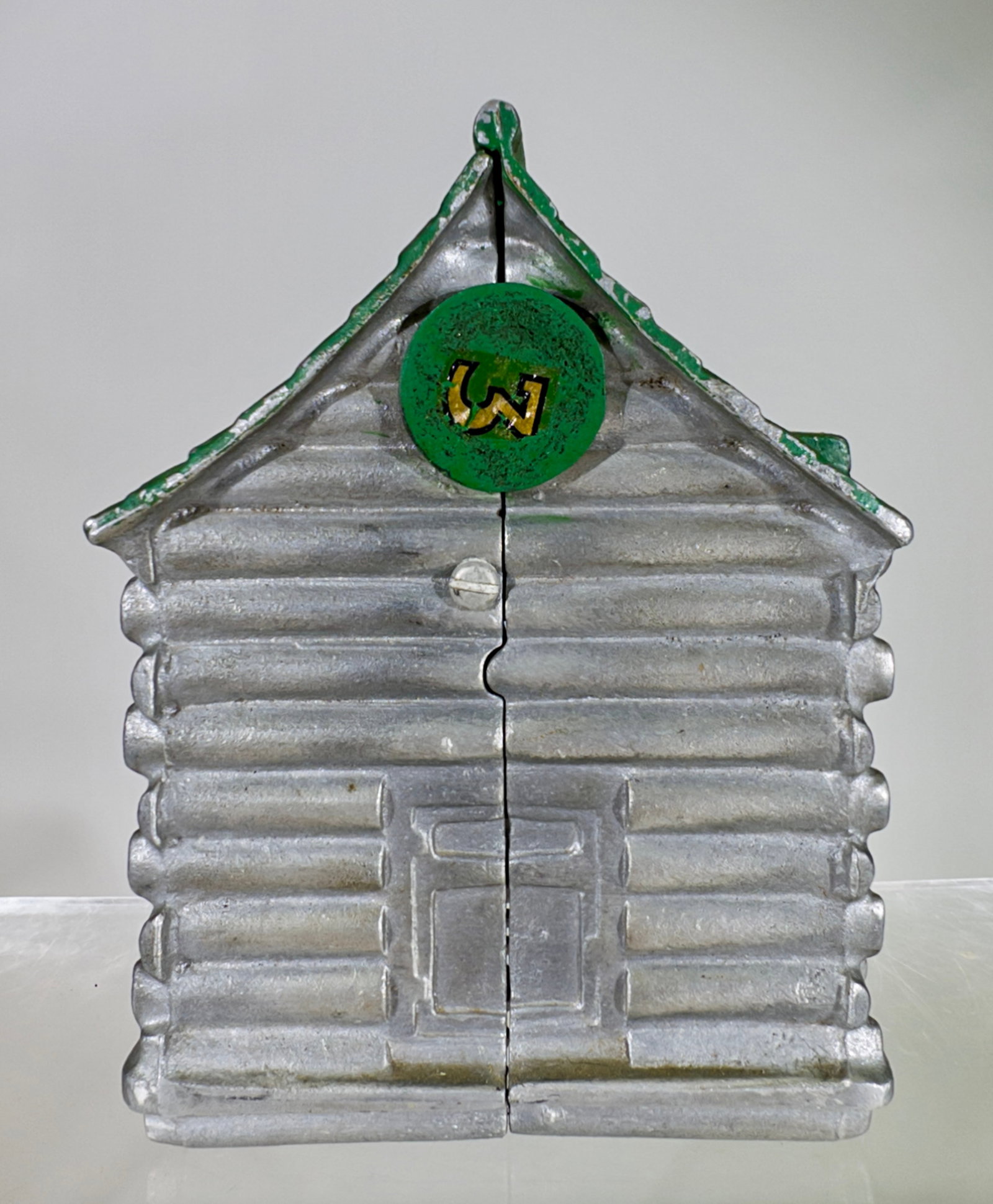 Aluminum Log Cabin Bank - Scarce: American - 1930's. 5 1/2" Tall x 4" Wide. Tom Kellogg Collection.