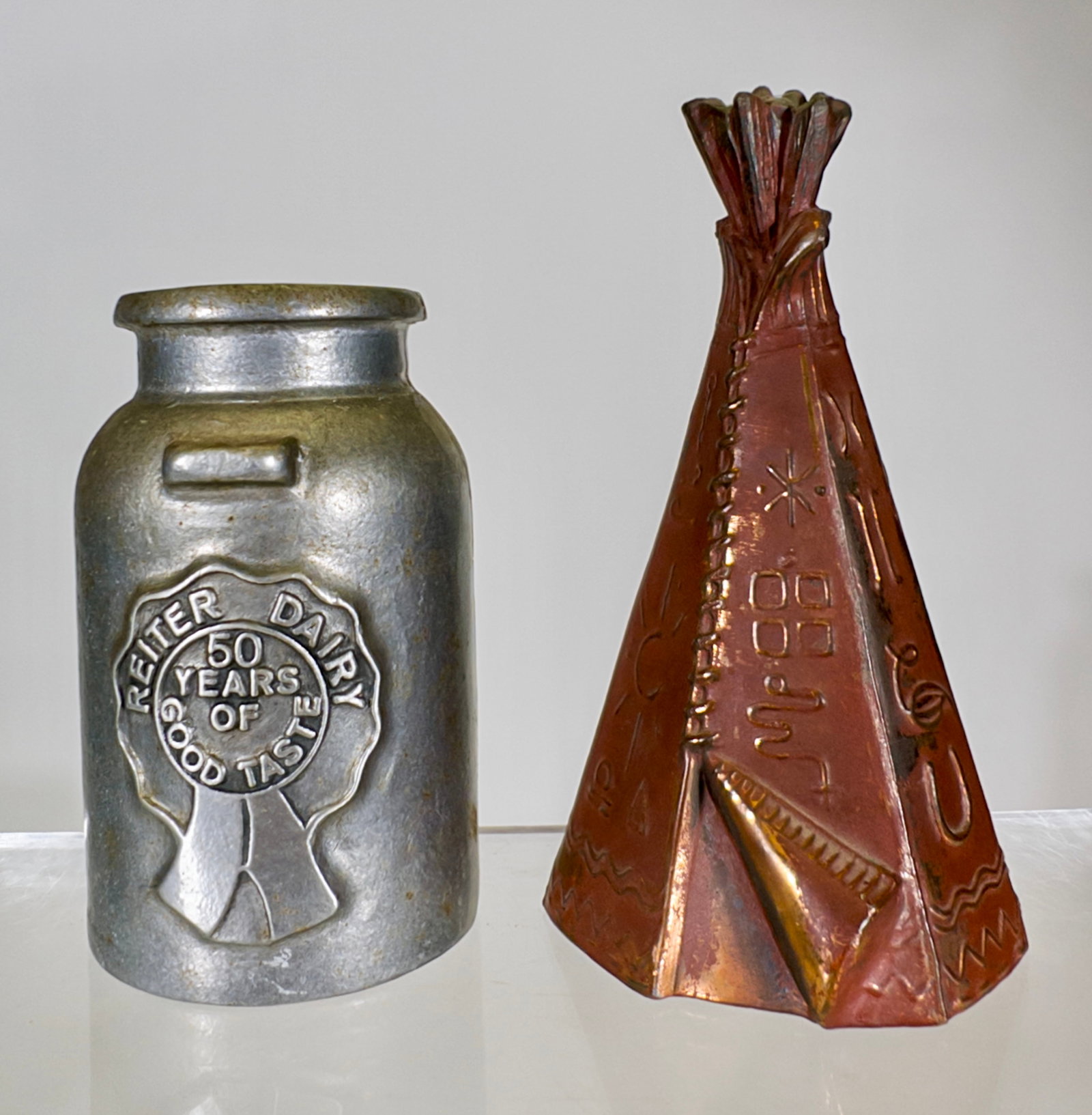 Two Aluminum Banks: American - 1950/1980's. Teepee Bank 5 1/2" Tall x 3"Circular. Tom Kellogg Collection.