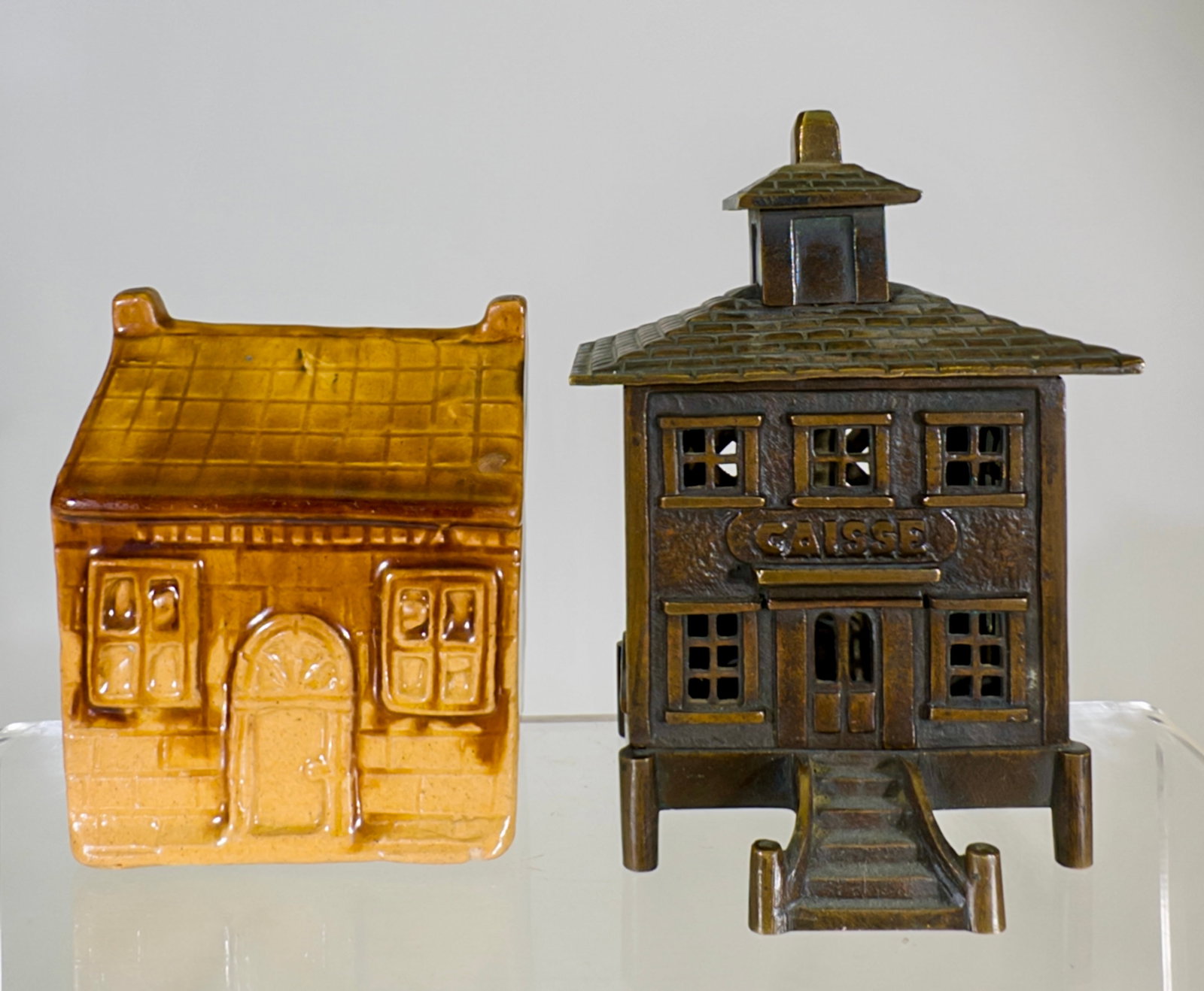 Brass Caisse & Porcelain Cottage - Still Banks: European - 1910/1920's. Caisse is 5" Tall x 3 1/2" Wide. Tom Kellogg Collection.