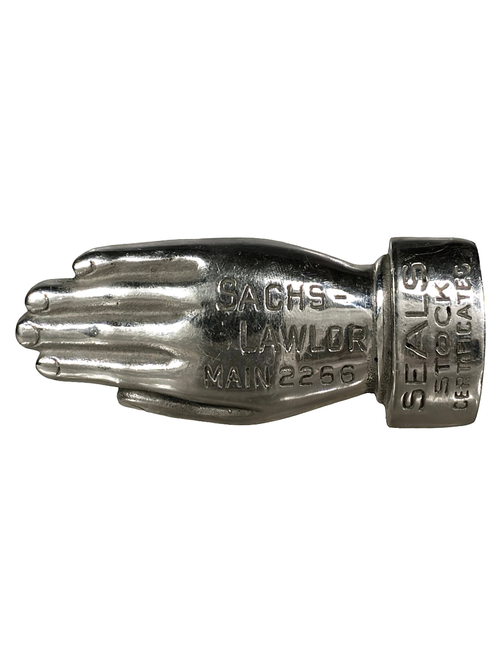 Sacks - Lawlor Advertising Paperweight: Made of a Heavy Lead Alloy. American - Circa 1930's. 3 1/2" Wide x 1 1/2" Tall. The Peirce Collection.