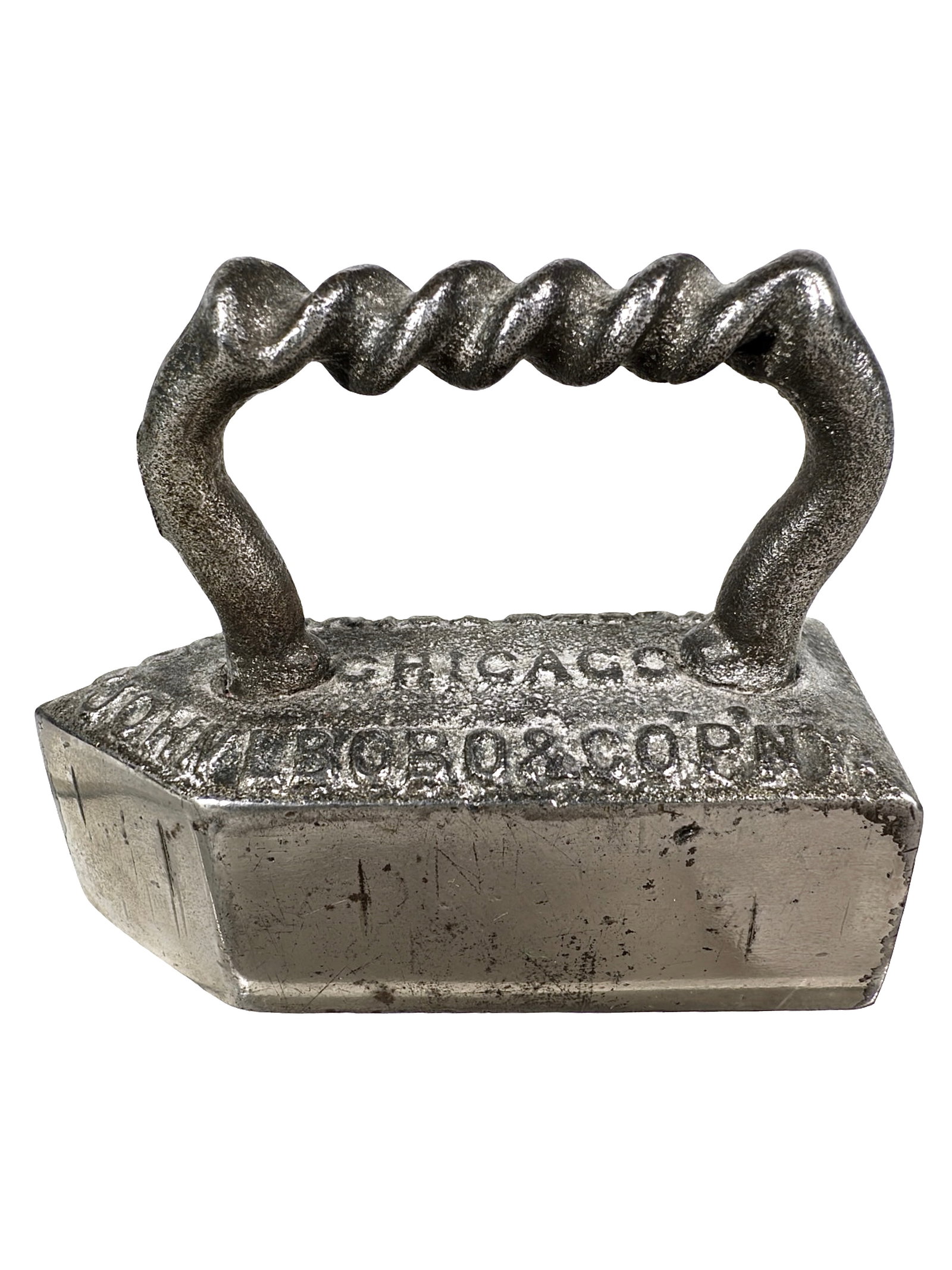 John L. Bobo & Co. Advertising Paperweight - Tailors & Trimmings: Cast Iron. American - Circa 1900's. 2 3/8" Tall x 2 7/8" Wide. The Peirce Collection.