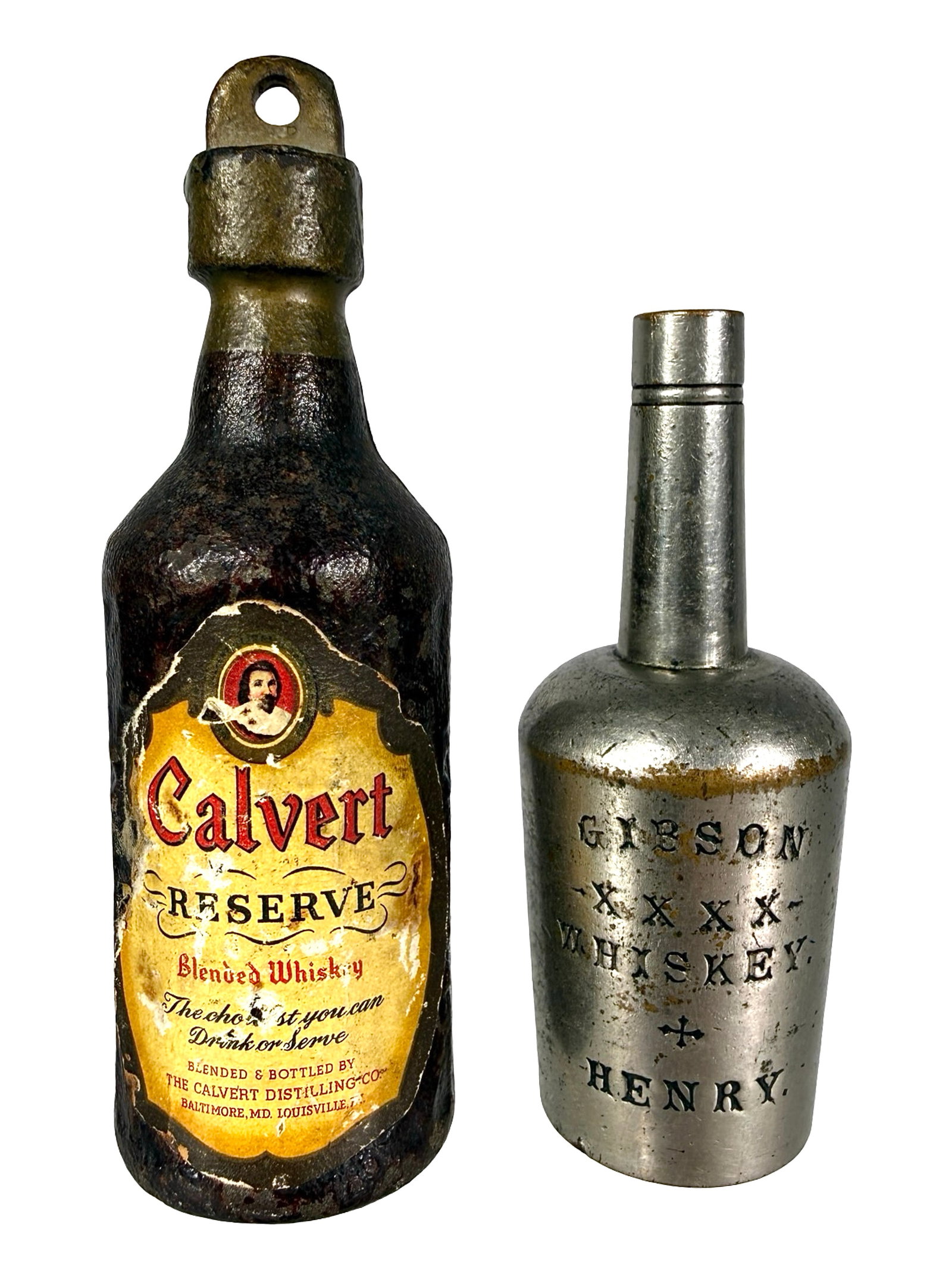 Two Whiskey Paperweights: One Brass and One Cast Iron. American - Circa 1910/40's. Calvert Whiskey is 3 3/4" T x 1 1/4" W. The Peirce Collection.