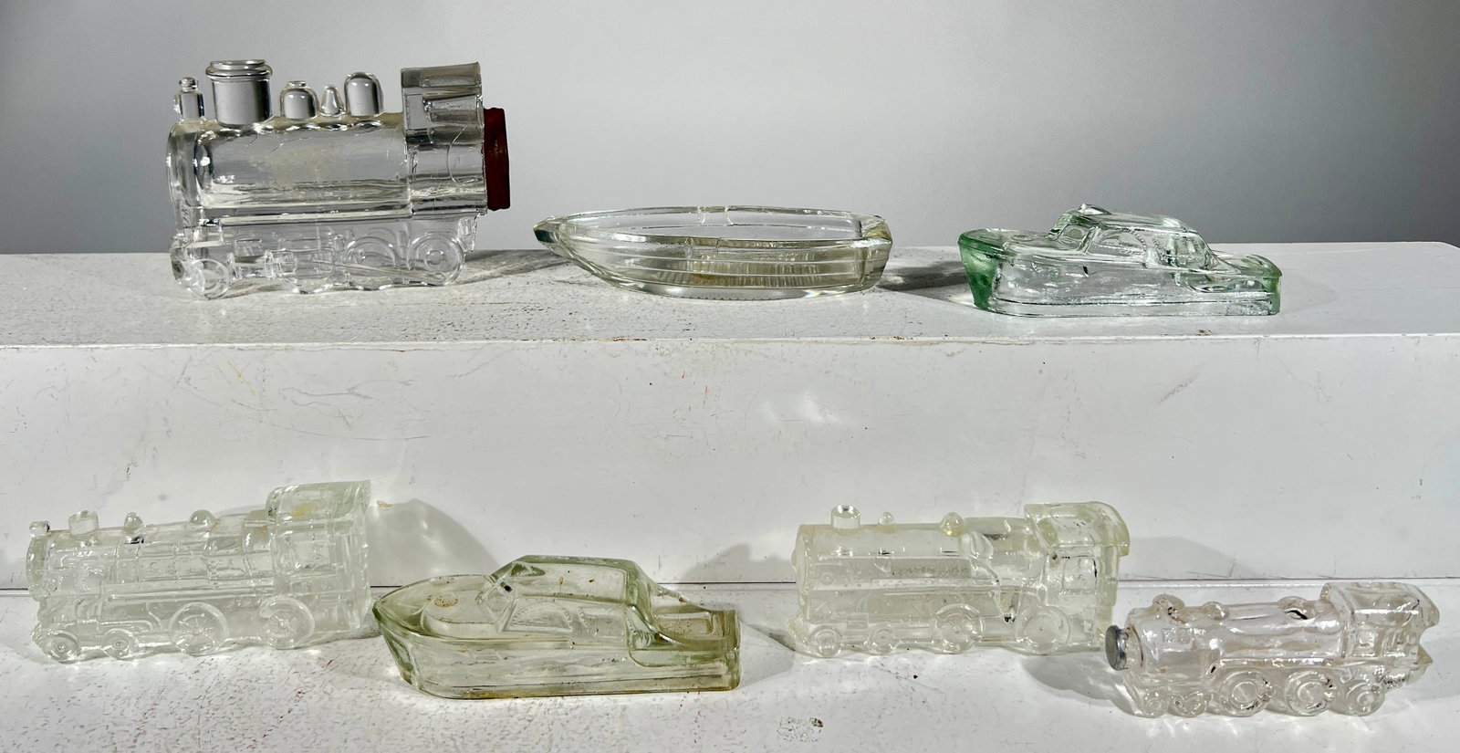 Four Locomotive and Three Boat Glass Candy Containers (1 of 2)