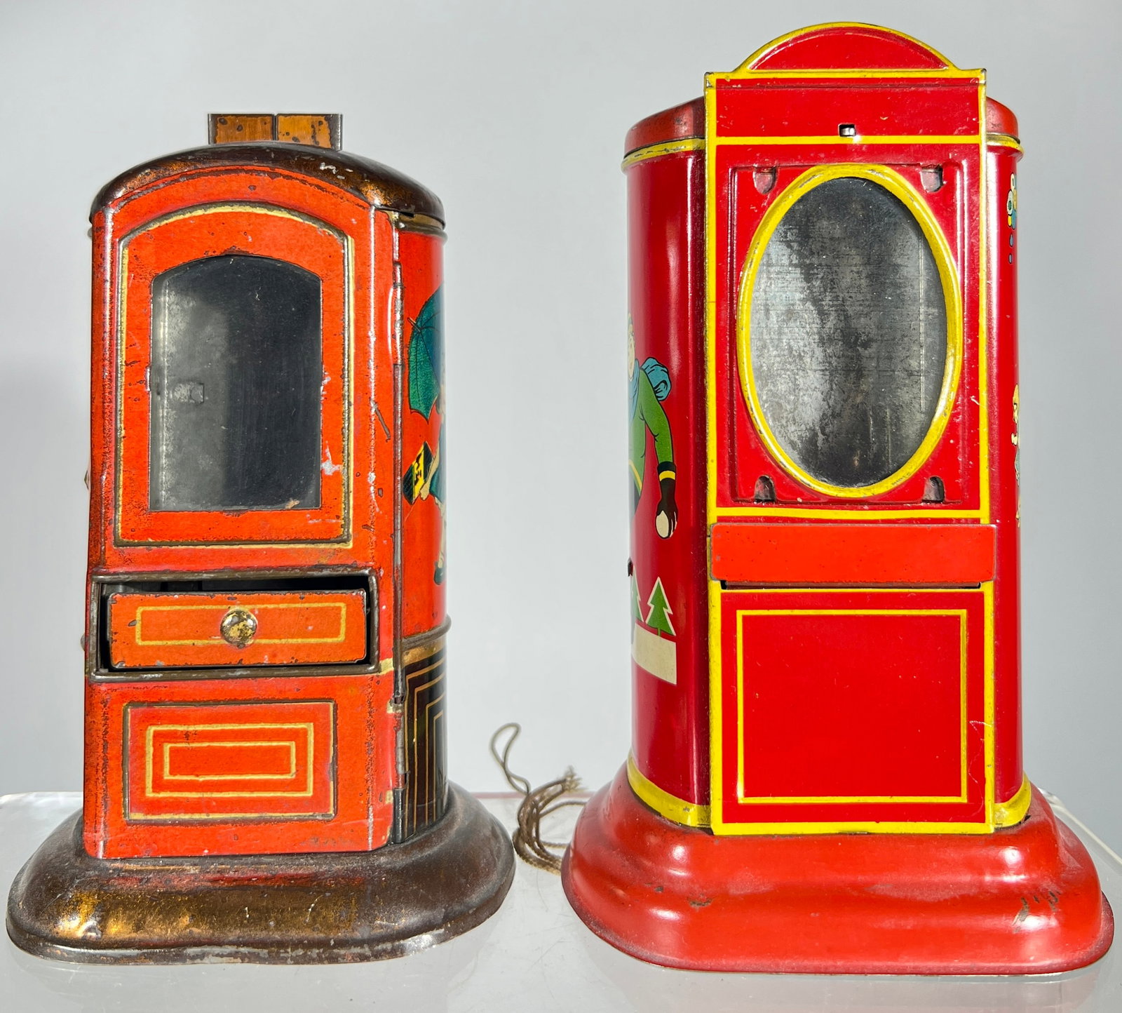 Two Oval Window Vending Banks: German - 1920's - 6 1/4" T - The Peirce Collection