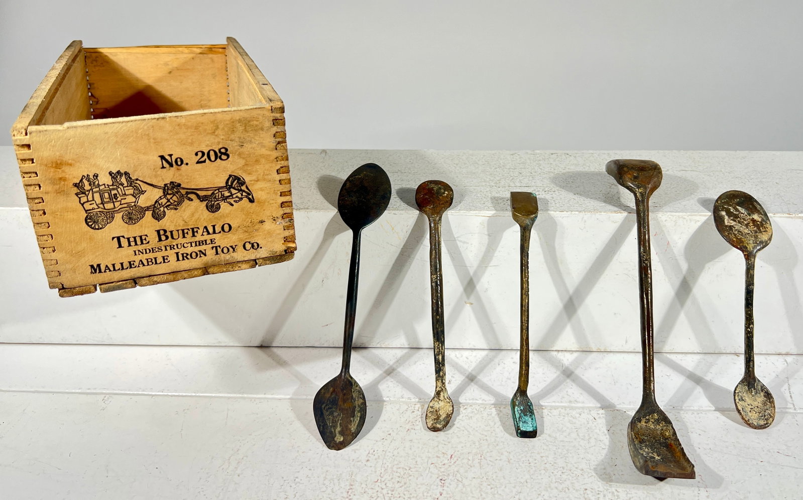 Buffalo Toys Wooden Box with Five Cast Iron / Brass Tools: American 1980 - Box is 10 5/8"L x 3 1/4"T - Box is probably newer - The Olshefski Collection