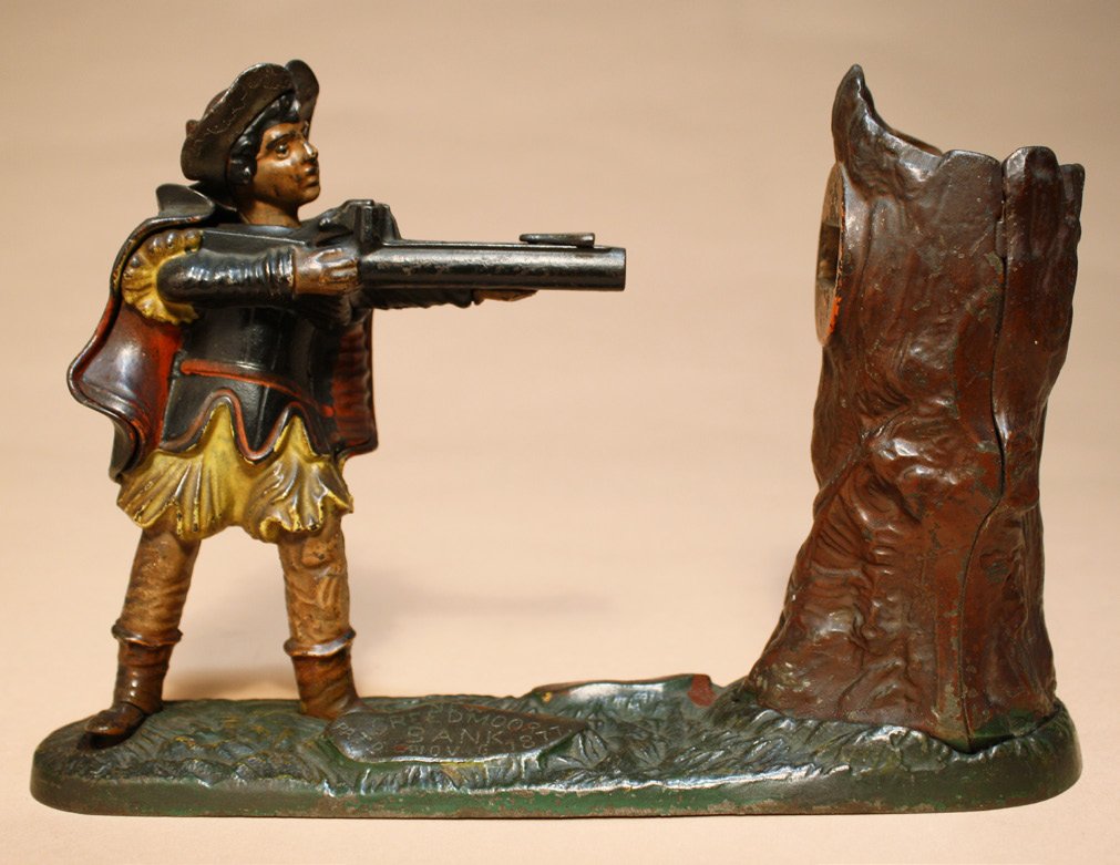 New Creedmoor Bank: Made by the J. & E. Stevens Company Cromwell, Connecticut Ð Circa 1890 Place the coin flag on the rifle and push his foot. The coin is fired into the tree. Material: Cast Iron