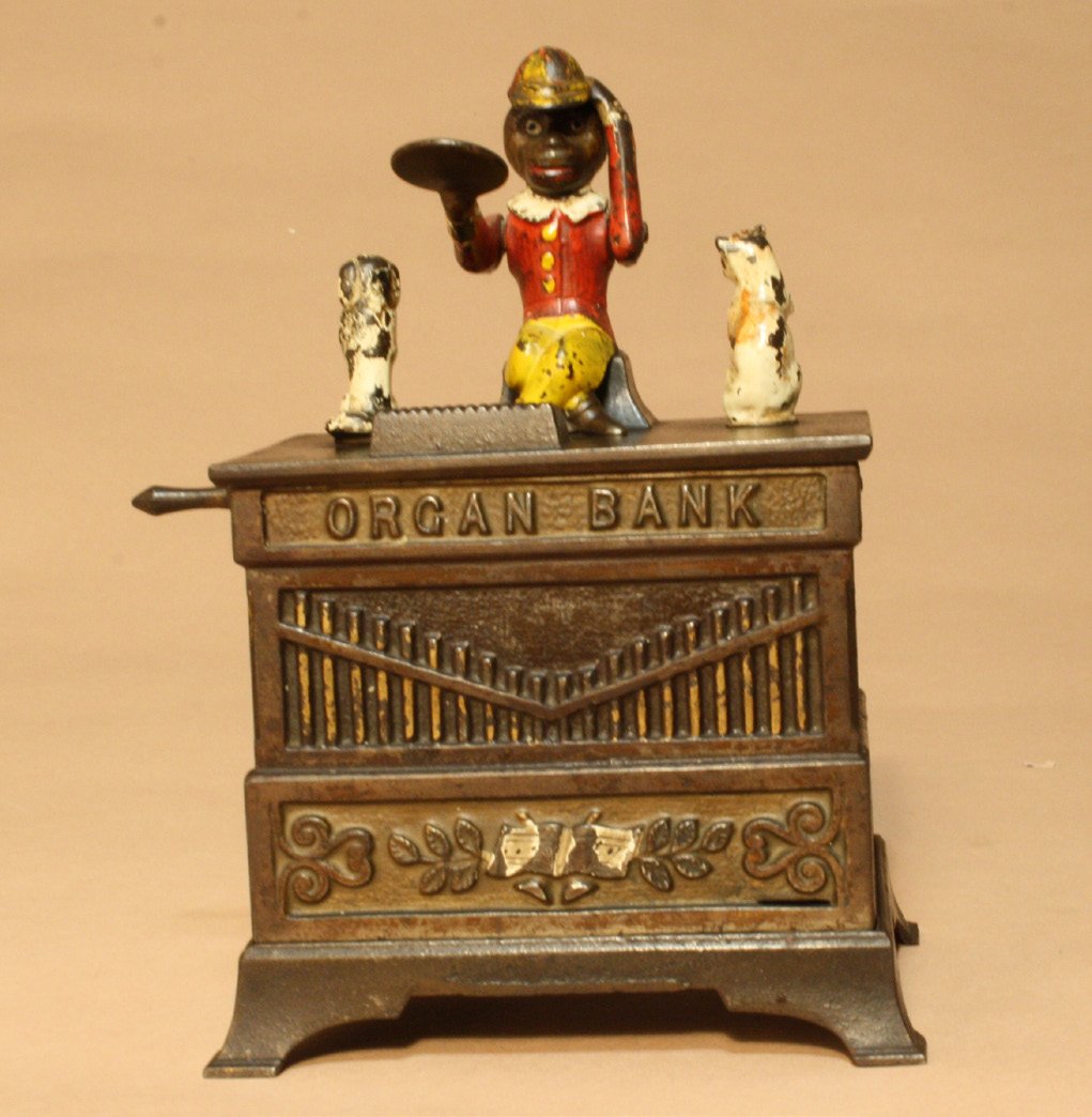 Organ Bank, Cat and Dog: Kyser & Rex Company Philadelphia, Pennsylvania ÐCirca 1882 The monkey doffs his hat in thanks for the penny you have given him. The dog and cat rotate and the bells chime when the crank is turned. Ma